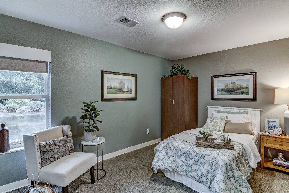 A modern and comfortable bedroom with tasteful decor and furniture.