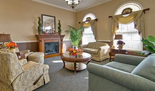 A traditional living room with comfortable seating, a fireplace, and elegant decor.