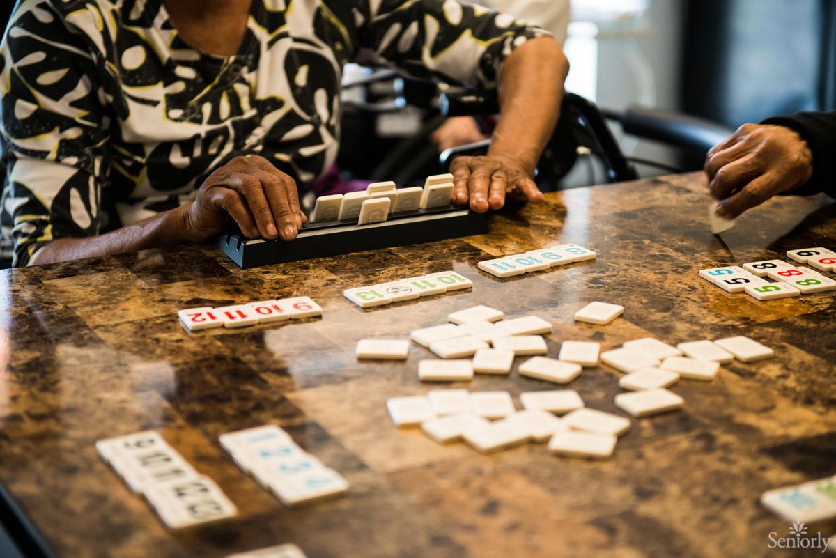 A person playing a game of dominoes at a table.
