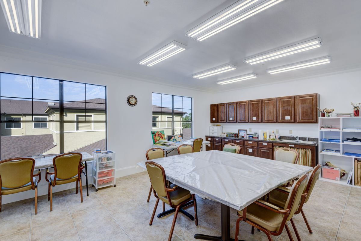 A bright kitchen and dining area with a large table, chairs, and ample cabinet space.
