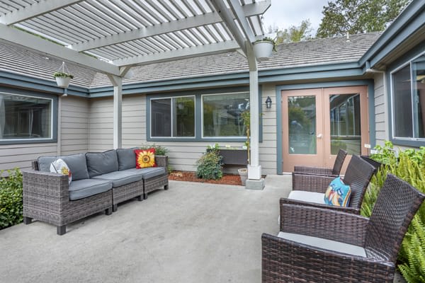 A modern patio with outdoor seating and a pergola.