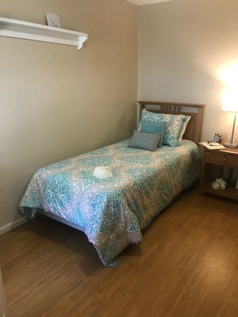 A cozy bedroom with a single bed and nightstand.