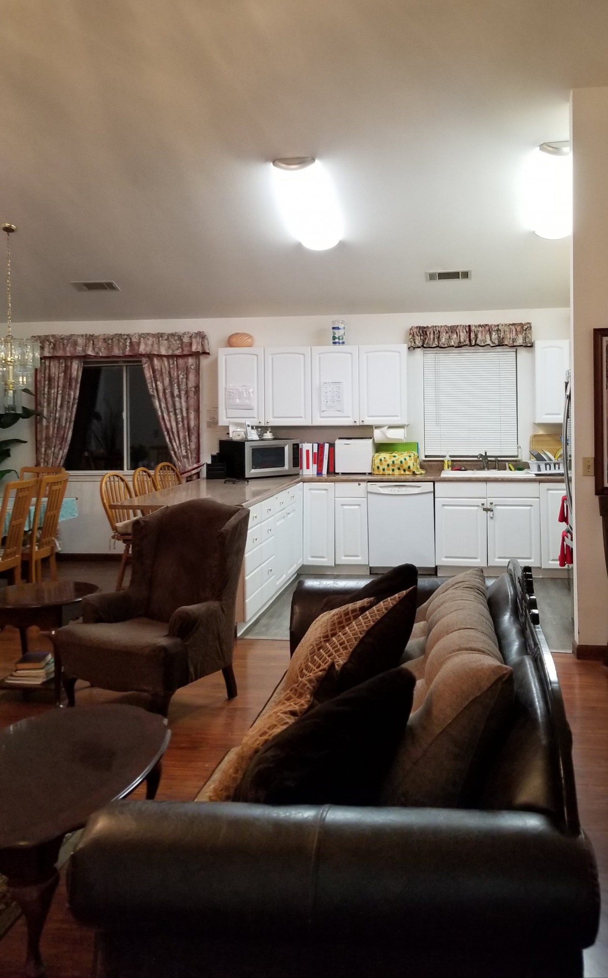 A cozy open-concept living room and kitchen space with furniture and home decor.