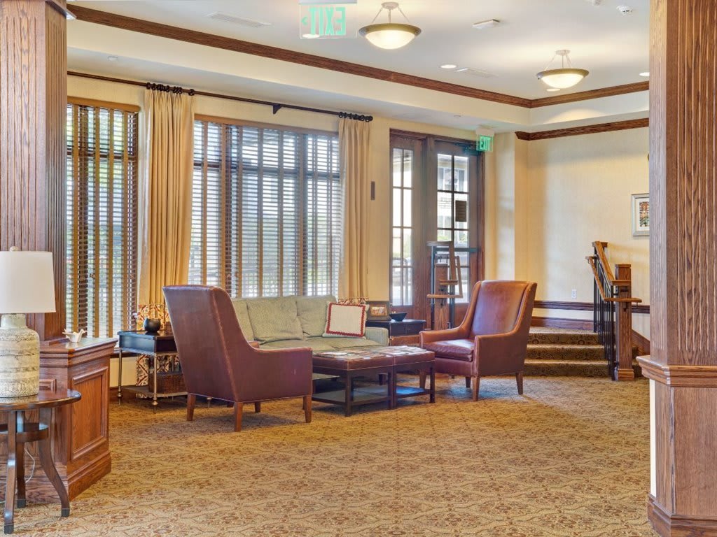 A cozy living room with comfortable seating and large windows.