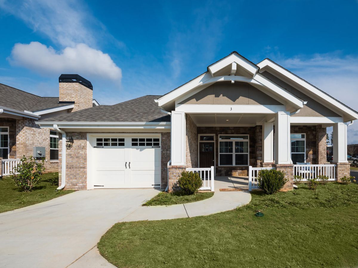 A single-story suburban home with a well-maintained lawn and an attached garage.