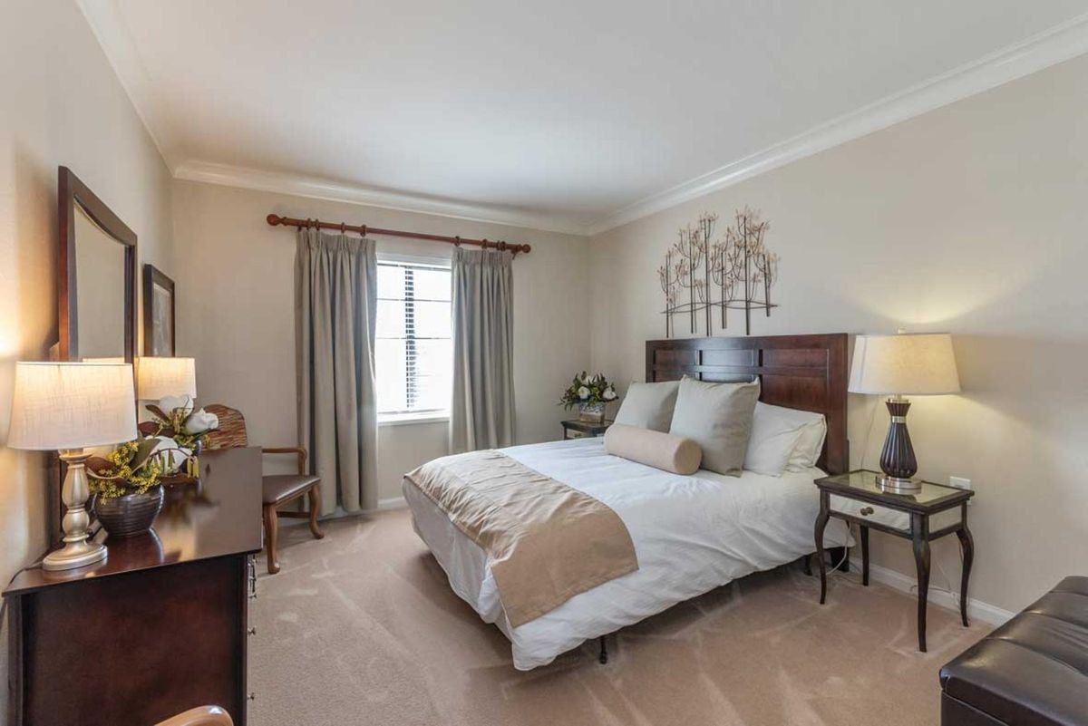 A cozy bedroom with neutral tones and elegant decor.