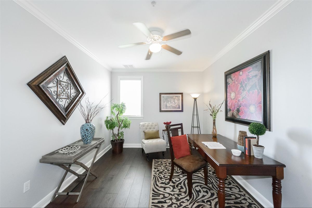 A modern home office with stylish decor and natural lighting.