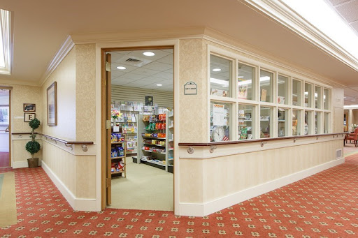 A glimpse into a retail space with shelves filled with products, seen through an open doorway.