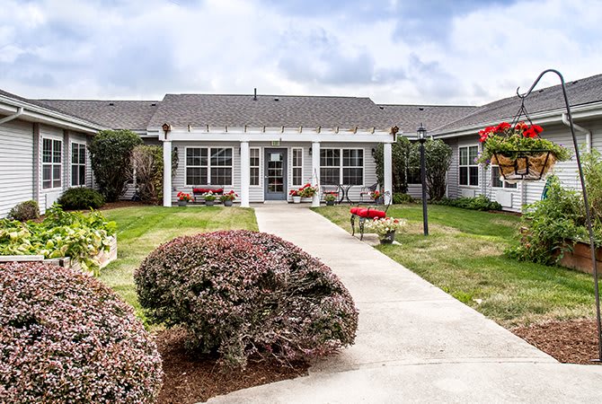 A charming house with a well-maintained garden and pathway.
