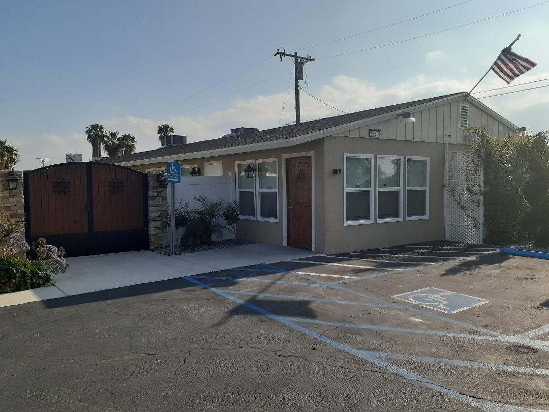 A small suburban building with handicap parking in front.