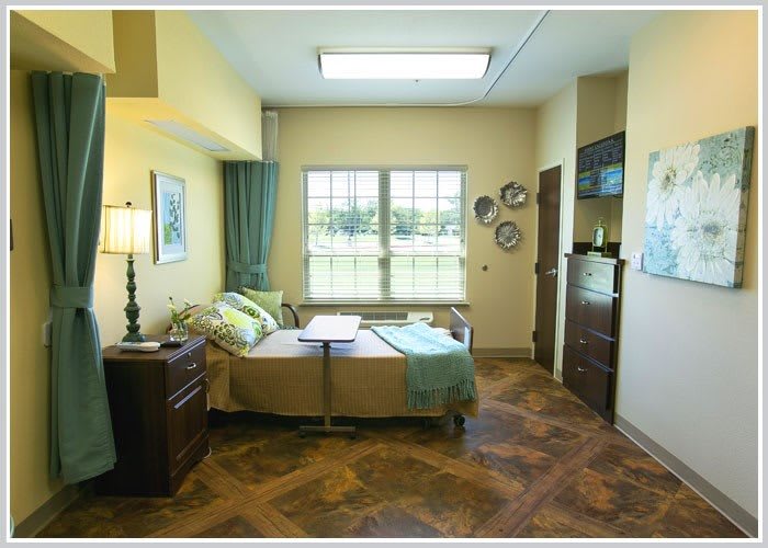 A cozy, well-lit hospital room with stylish decor and comfortable furnishings.