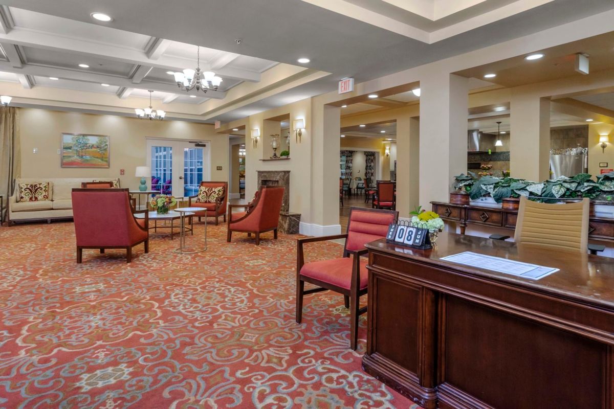 A spacious and elegantly designed lobby with comfortable seating and a reception desk.