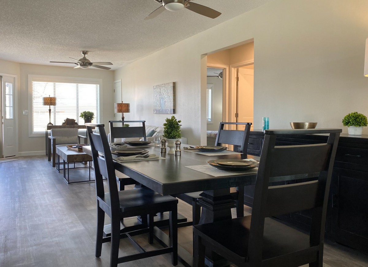 A modern dining room with a sleek table and chairs, tastefully set for a meal.