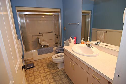A bathroom with a vanity sink, toilet, and bathtub.