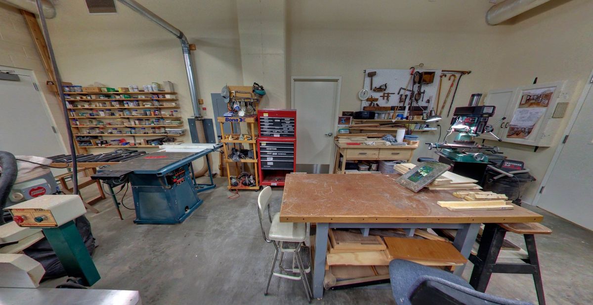 A well-equipped woodworking workshop with various tools and machinery.