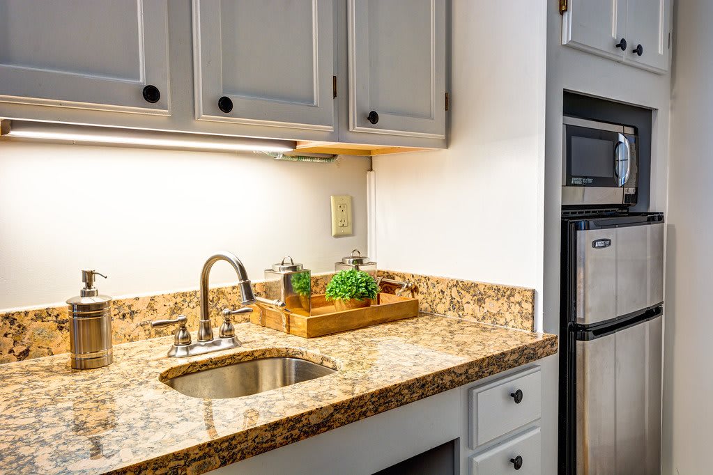 Modern kitchen with granite countertop and built-in sink.