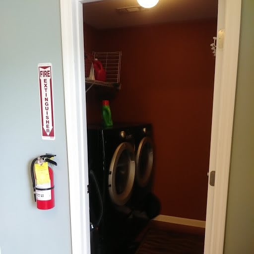 A view into a laundry room with a washing machine and dryer.