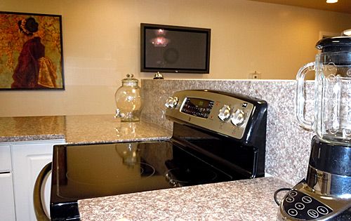 Modern kitchen with a granite countertop and built-in stove.