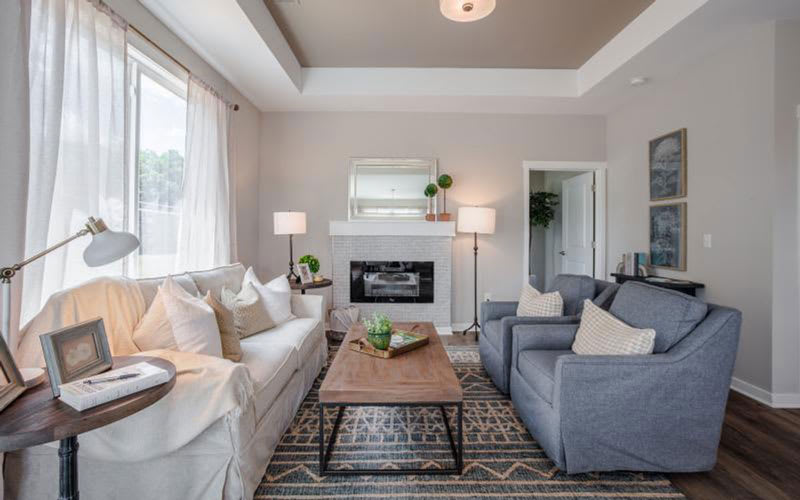 A modern and cozy living room with a stylish interior design, featuring comfortable seating and soft lighting.