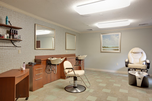 A modern and clean hair salon interior featuring styling chairs and mirrors.