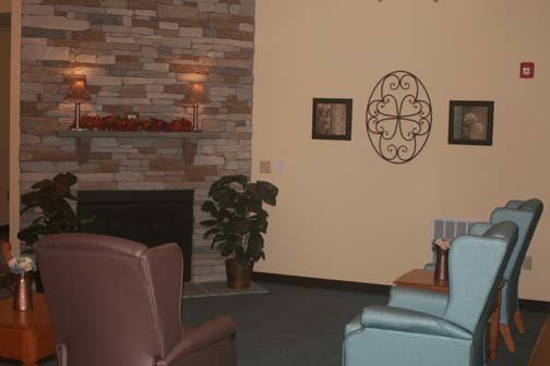 A cozy living room with a fireplace, comfortable seating, and decorative elements.