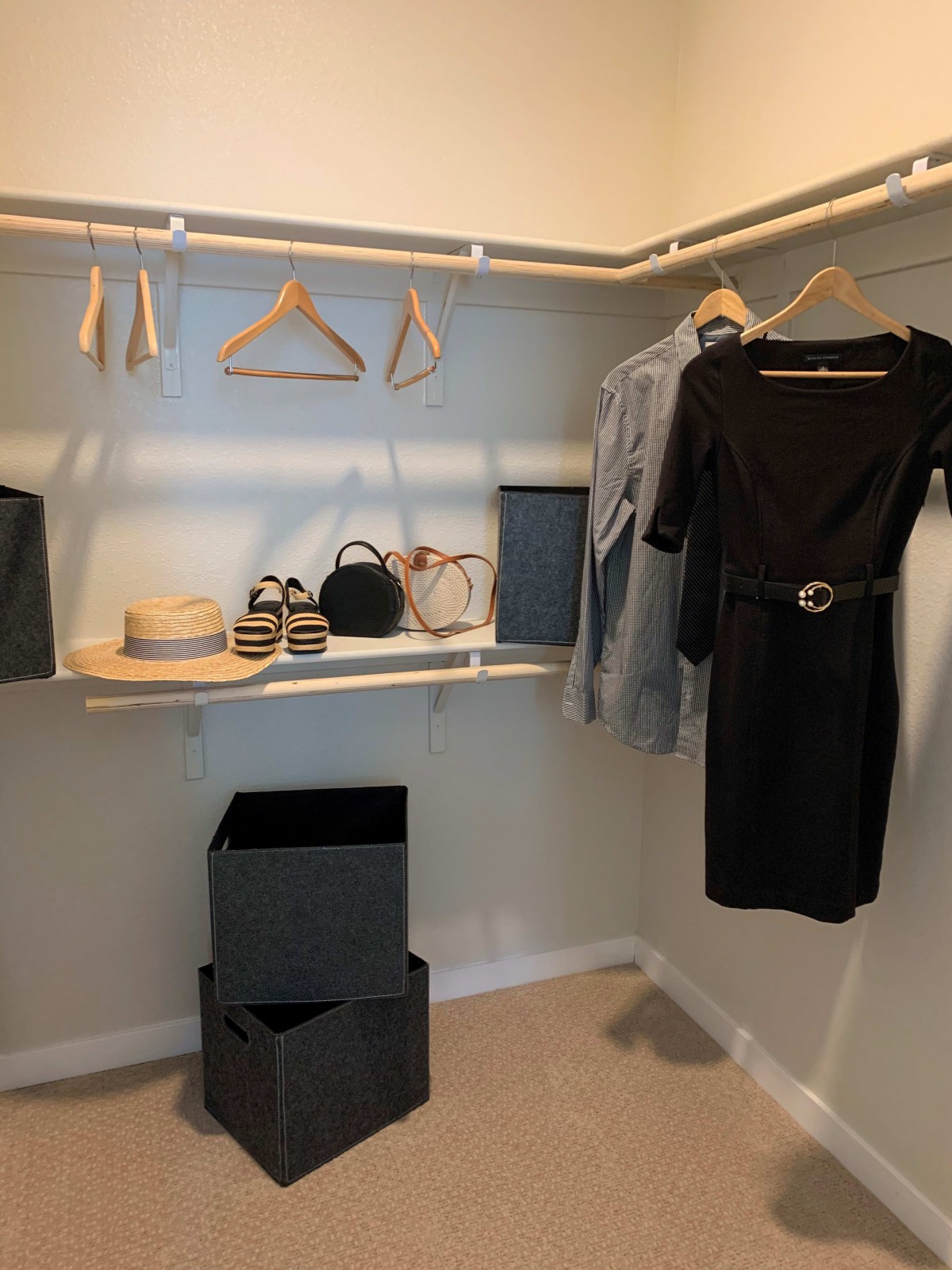 A neatly organized closet with clothes, hats, and accessories.