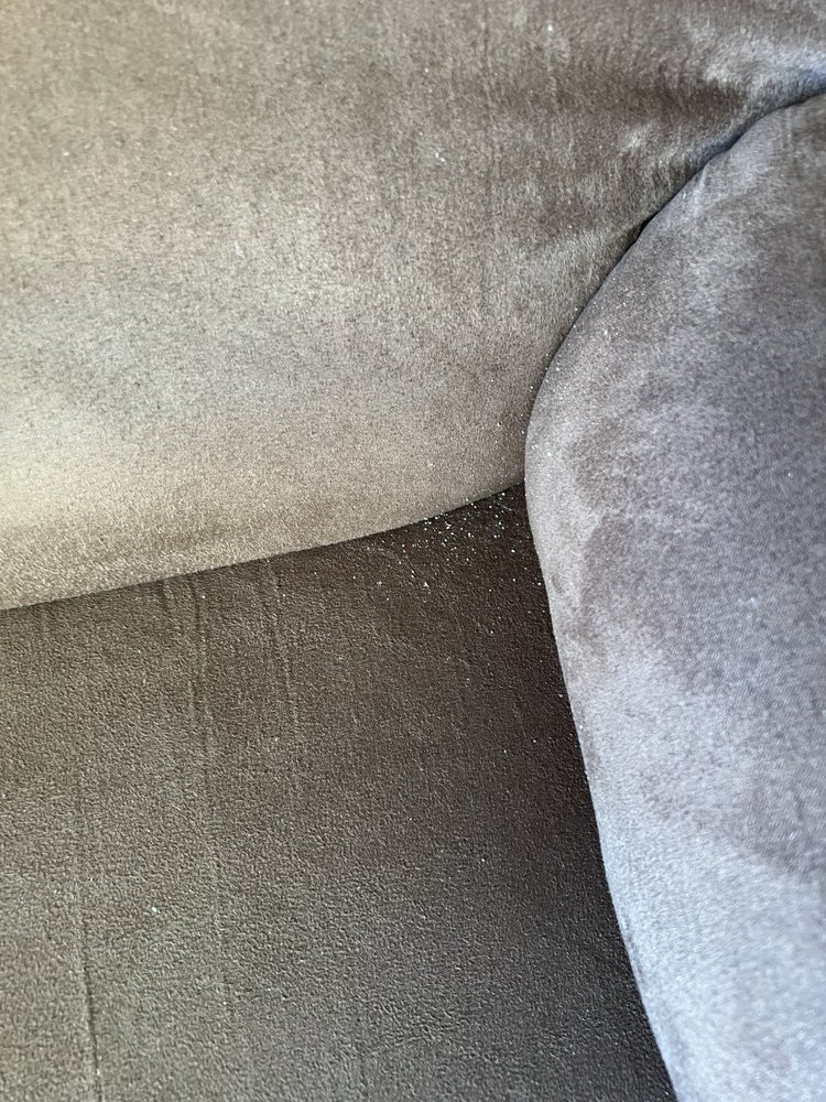 Close-up of a fabric cushion on a seat, showing the upholstery texture in a corner.