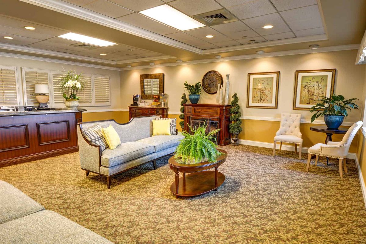Cozy and elegantly decorated lobby with seating area and artwork on the walls.