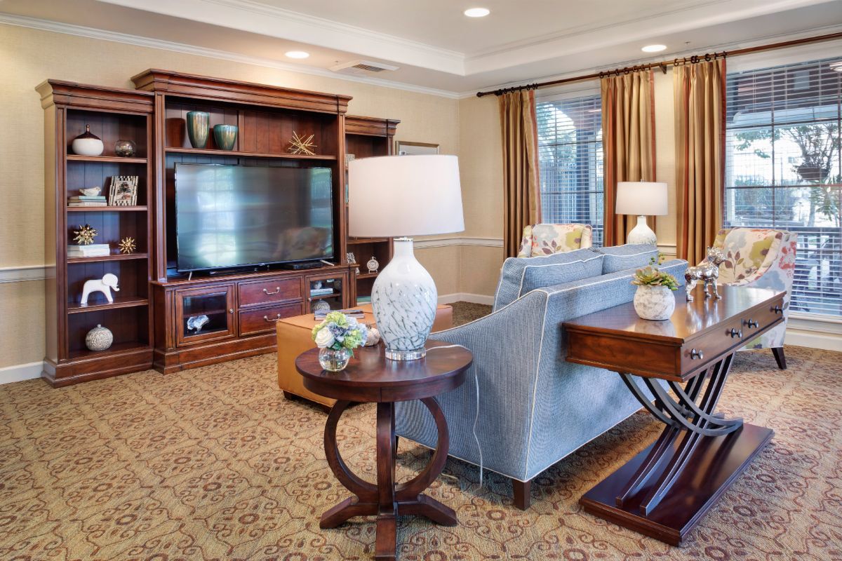 A cozy living room with elegant furniture and a large television.