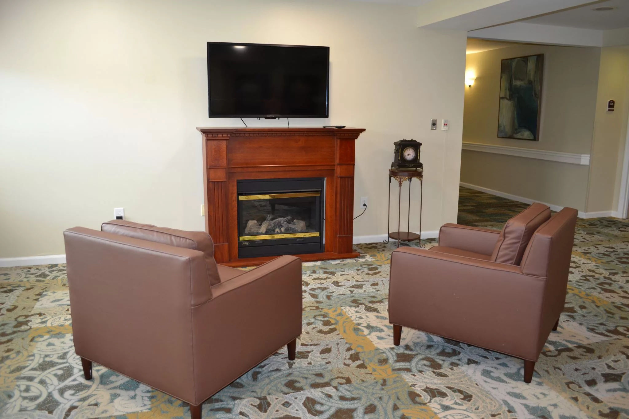 A cozy living room featuring a fireplace, television, and comfortable seating.