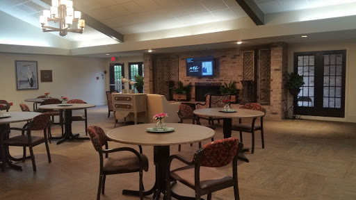 A cozy lounge area featuring tables and chairs, perfect for social gatherings.