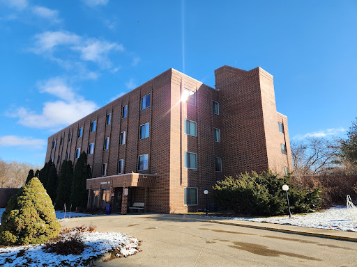 A modern brick building under a clear blue sky, showcasing architectural design.