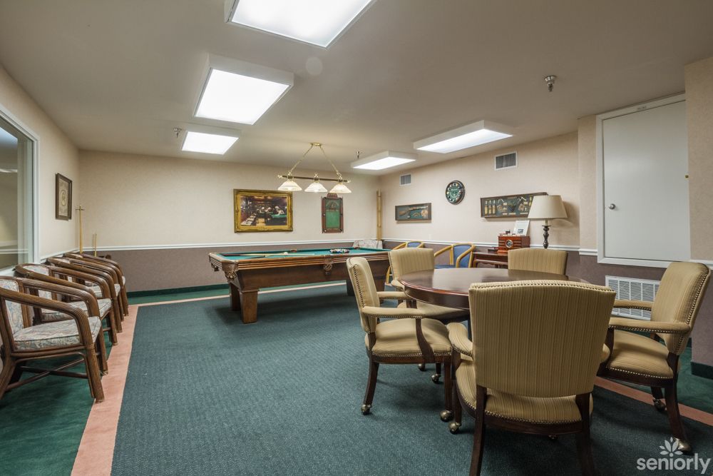 A cozy game room featuring a pool table and seating area.