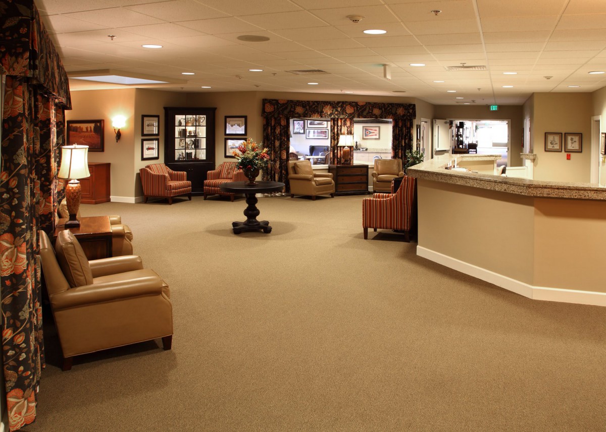 A spacious lobby with comfortable seating and a reception desk.