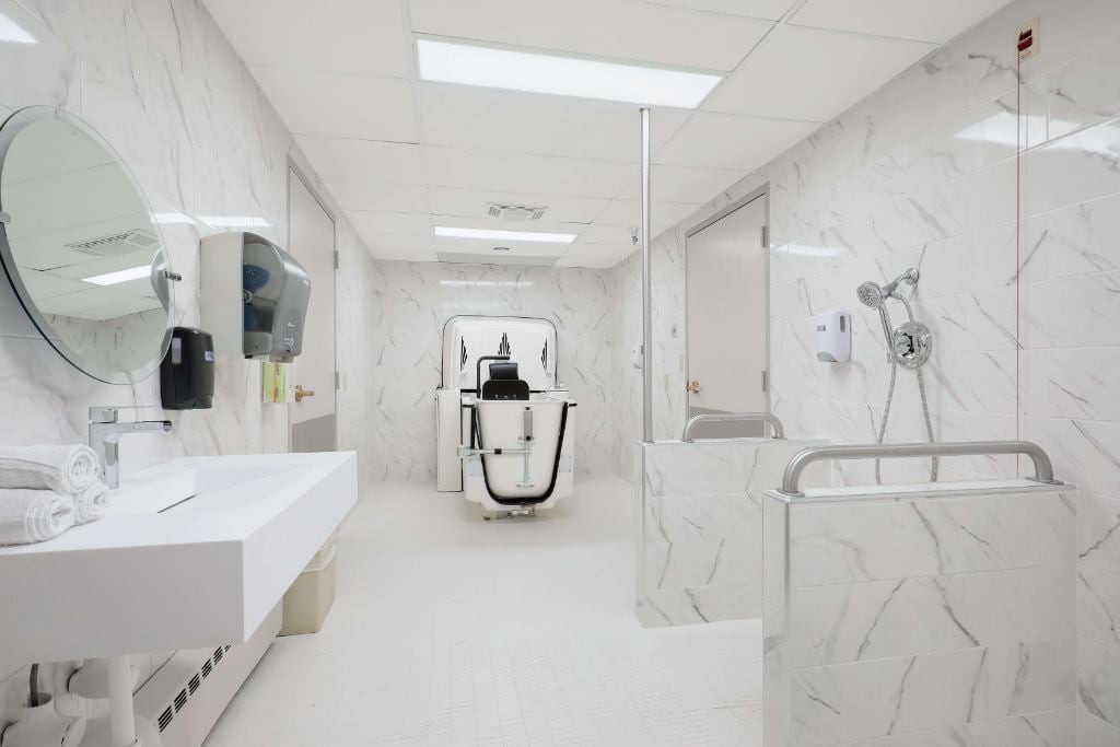 A clean and modern dental office with marble walls and advanced equipment.