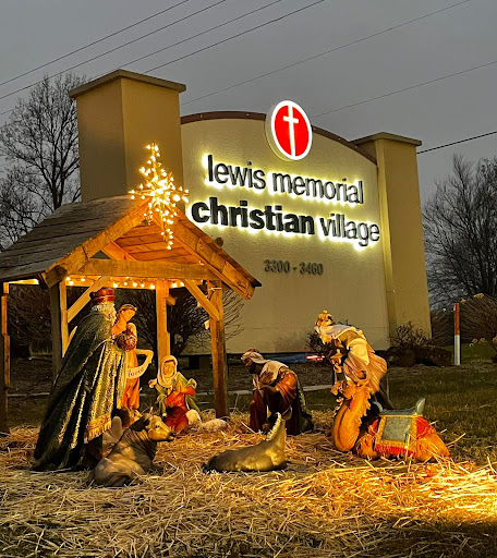 A nativity scene illuminated at night in front of the Lewis Memorial Christian Village.