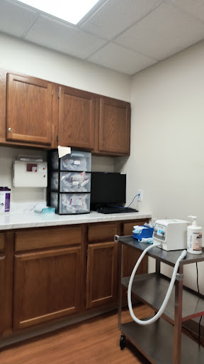 A glimpse into a medical office, featuring cabinets, storage, and essential equipment.