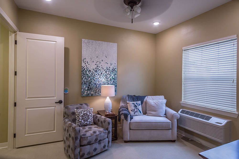A cozy living room corner with comfortable seating and warm lighting.