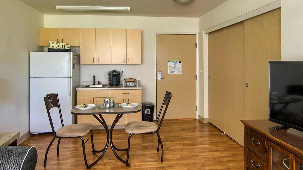 A cozy kitchen and dining area with a small table set for two.