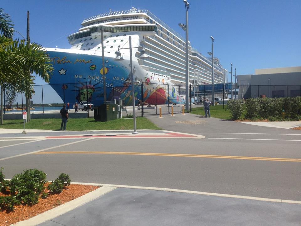 A large cruise ship docked at a harbor on a sunny day.