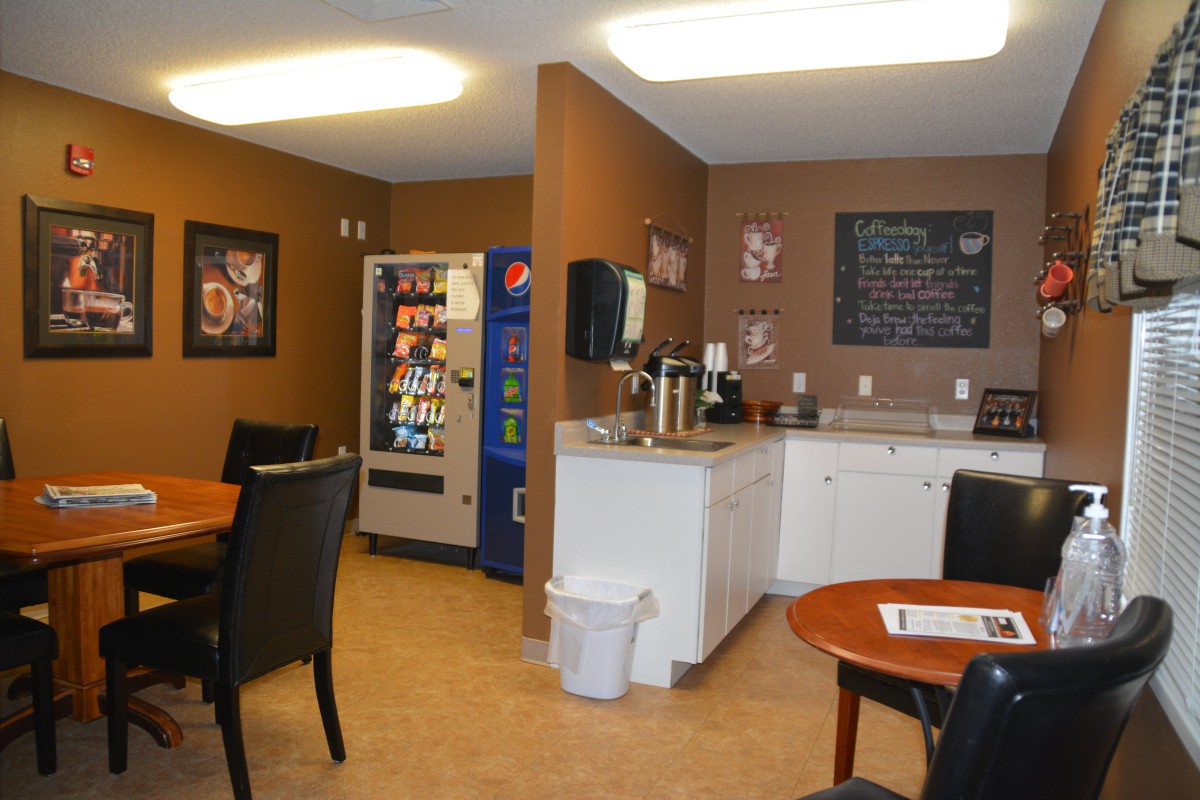 A cozy break room featuring a vending machine, coffee station, and seating area.