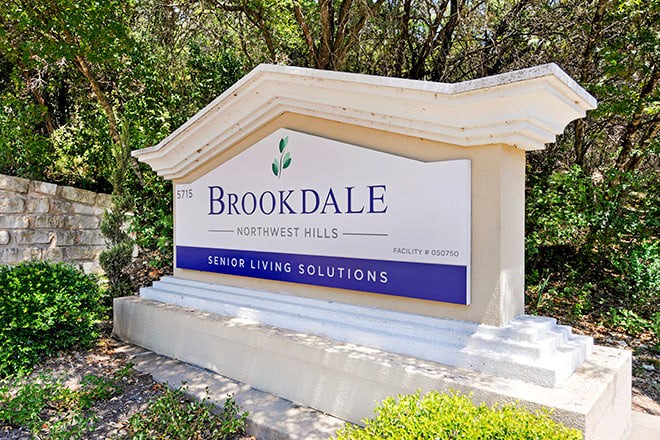 A sign for Brookdale Senior Living Solutions situated outdoors.