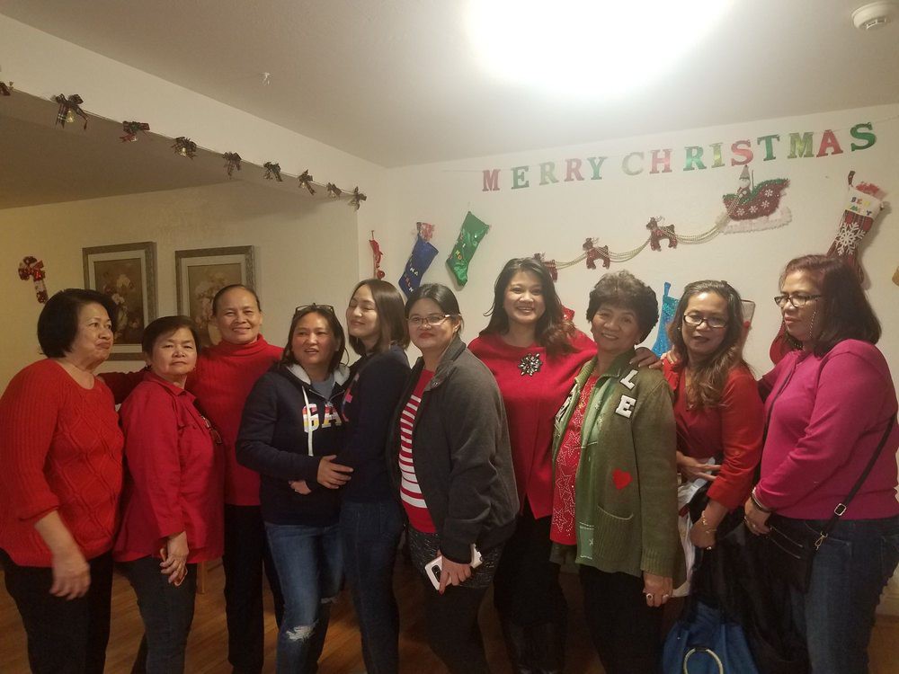 A group of people celebrating Christmas indoors.