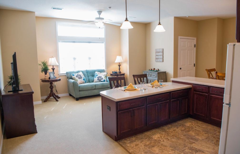 A cozy open-concept kitchen and living room with a central island and comfortable seating.
