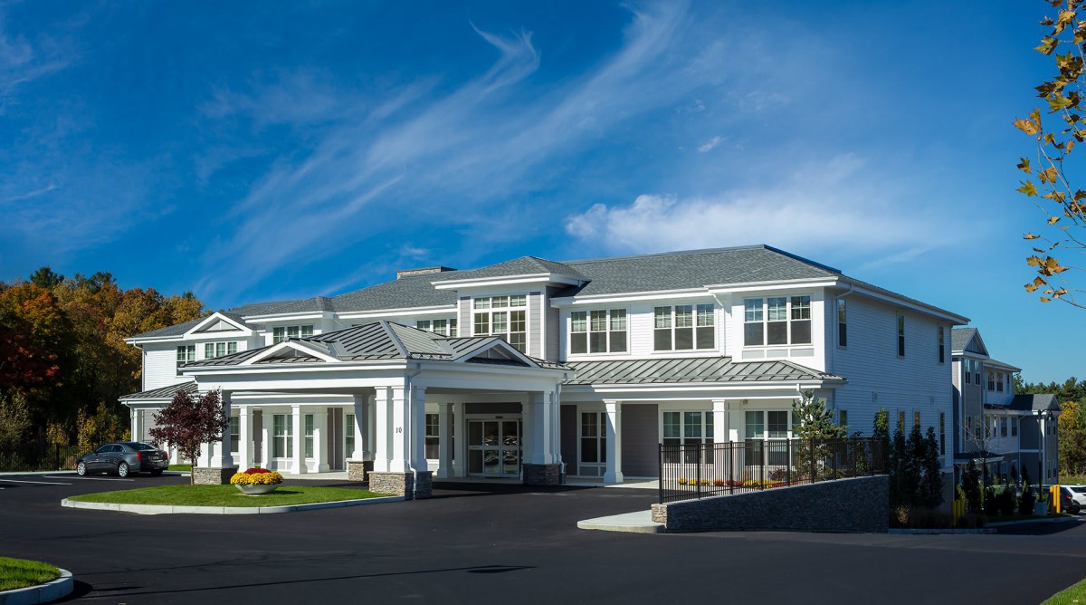 A large two-story residential building with a modern architectural design.