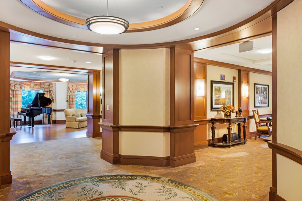 A spacious and elegantly designed hotel lobby with warm lighting and comfortable seating.