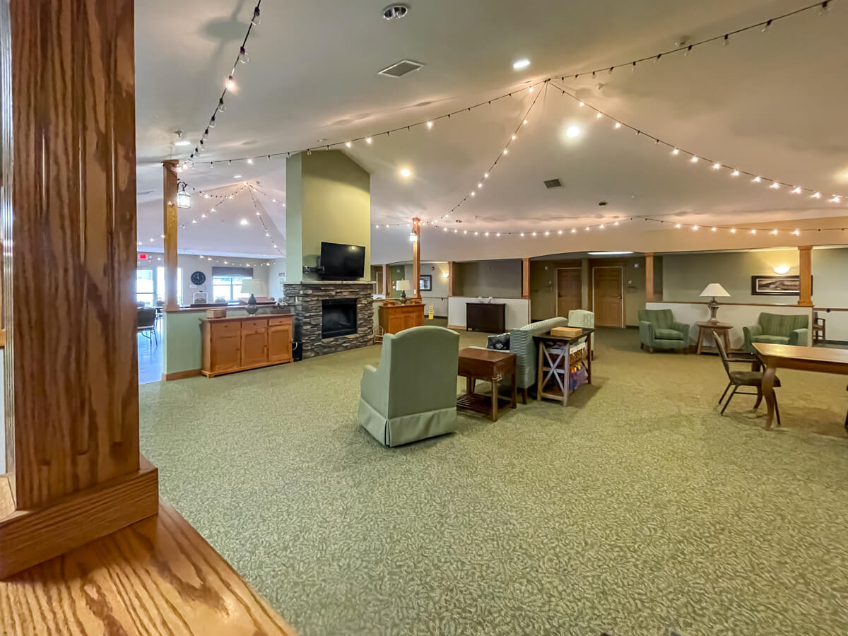 A spacious interior with comfortable seating, a fireplace, and warm lighting.