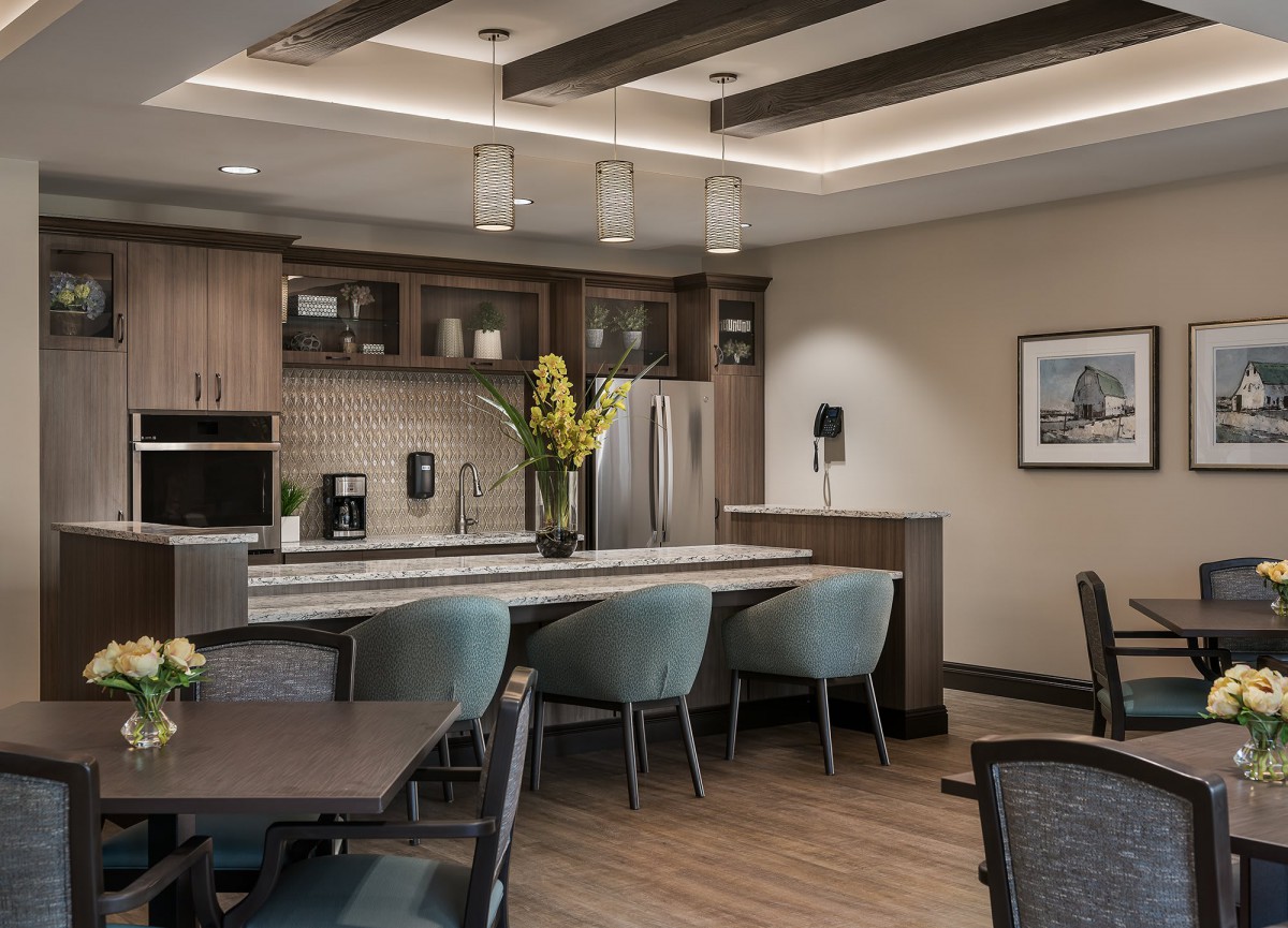 A modern kitchen interior with contemporary furniture and lighting.