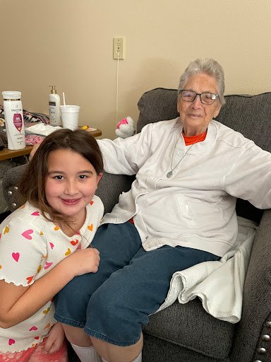 A joyful moment shared between a young girl and her grandmother.