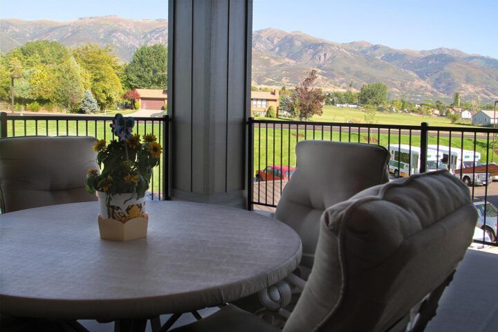 A patio with comfortable seating offers a scenic mountain view.